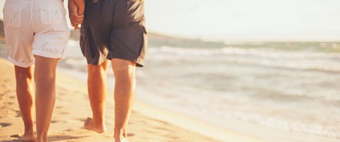 et par ikledd shorts går tur på en strand. foto.